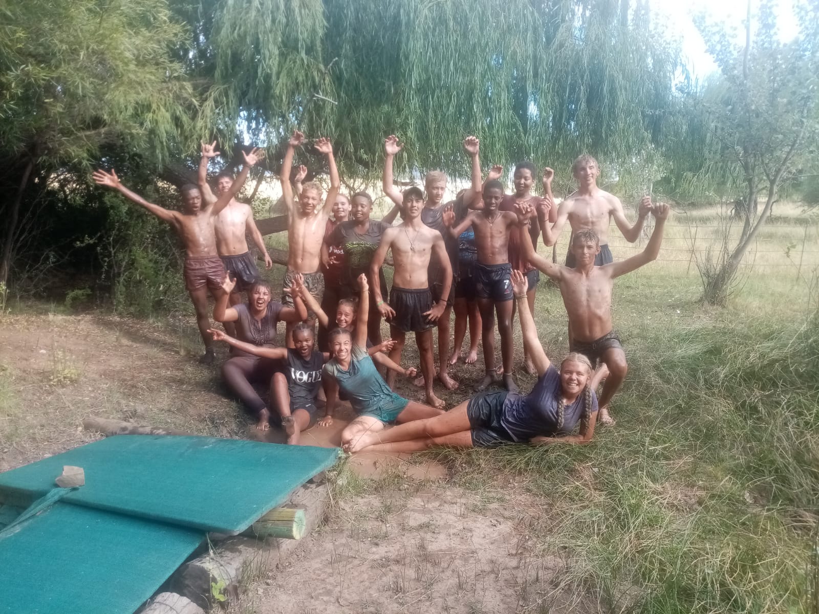 Team crossing a mud pit during a teamwork challenge